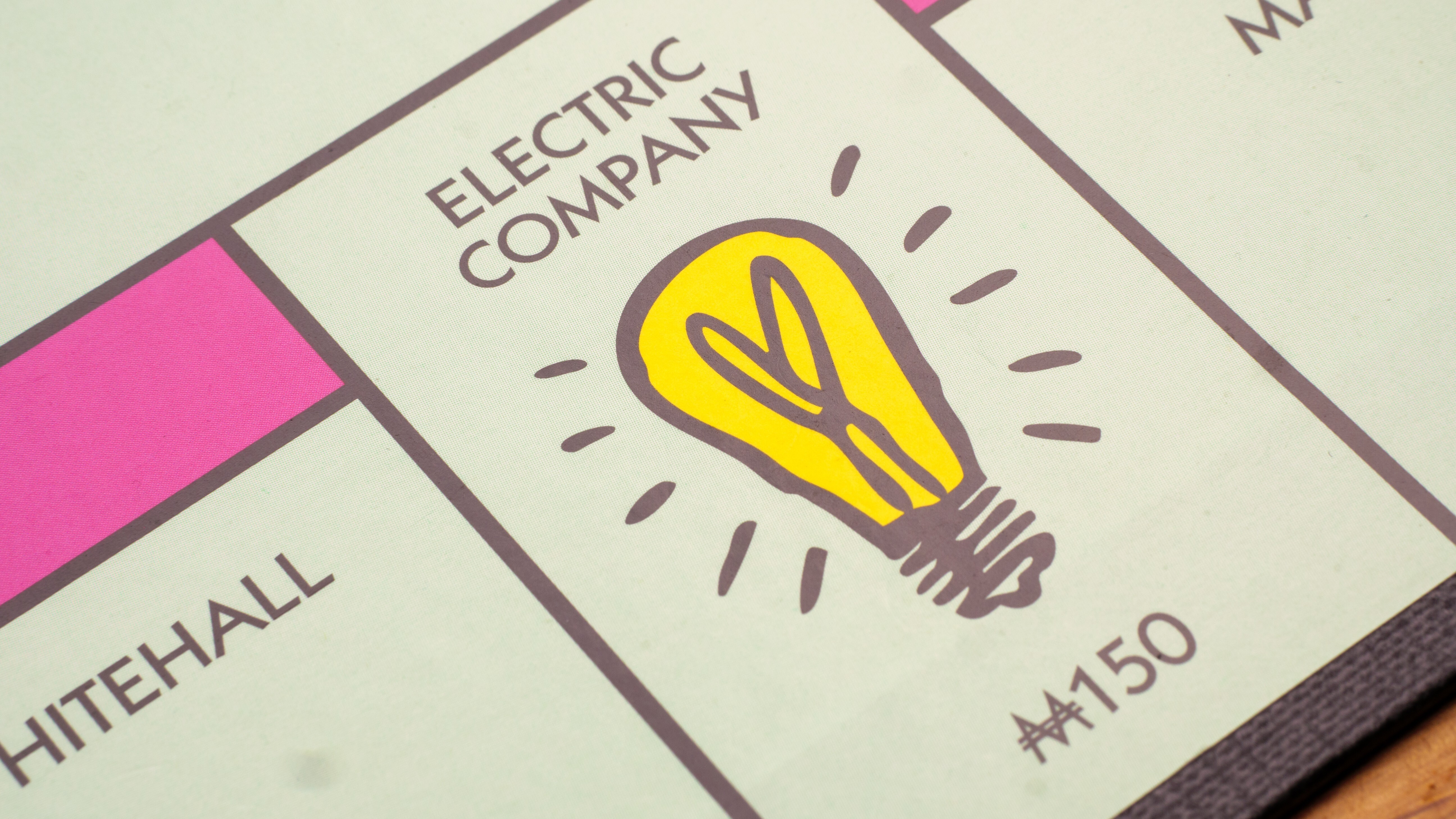 Close up of Electric Company square on a Monopoly board game