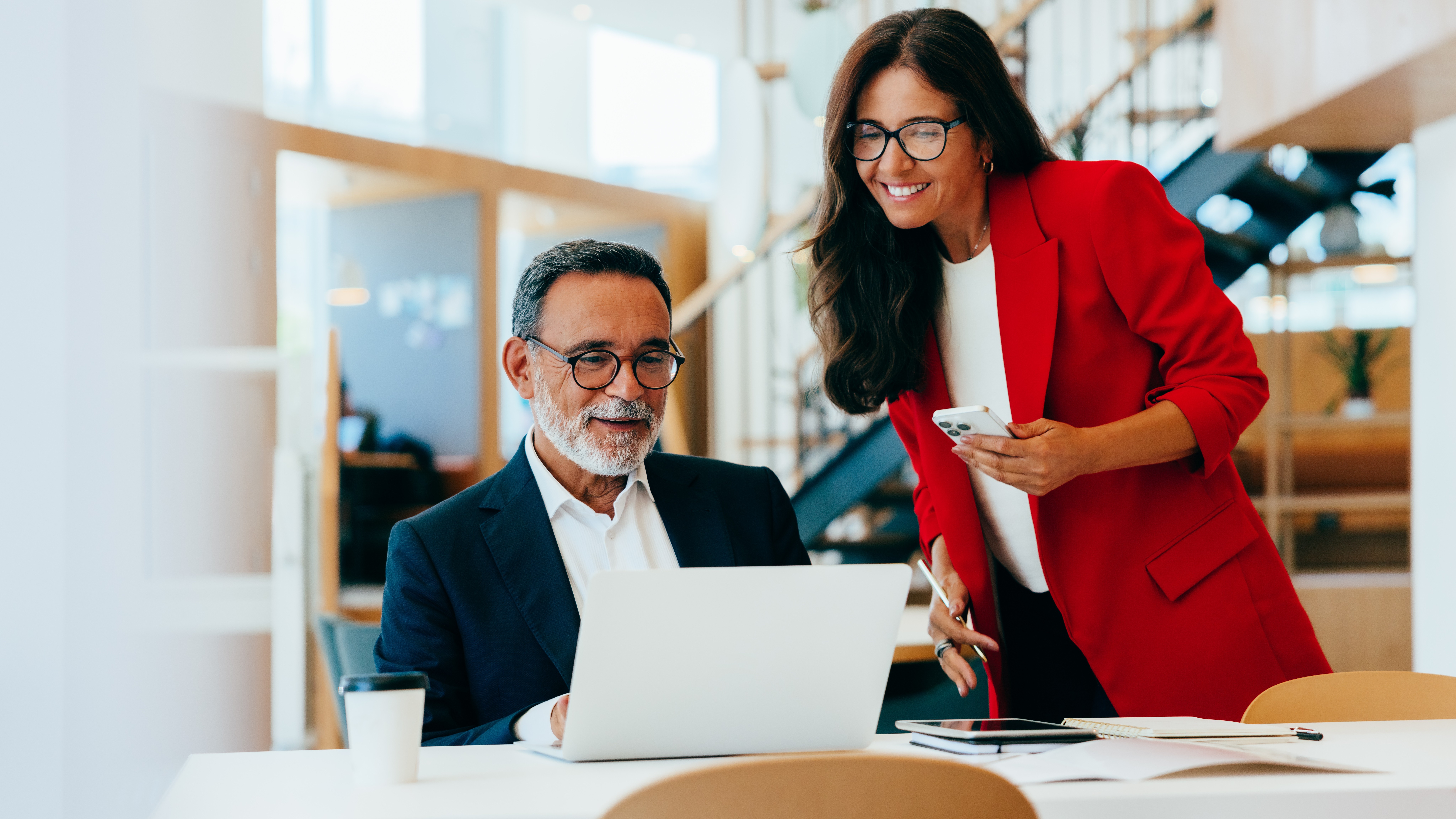 Two senior business professionals working together in an office environment