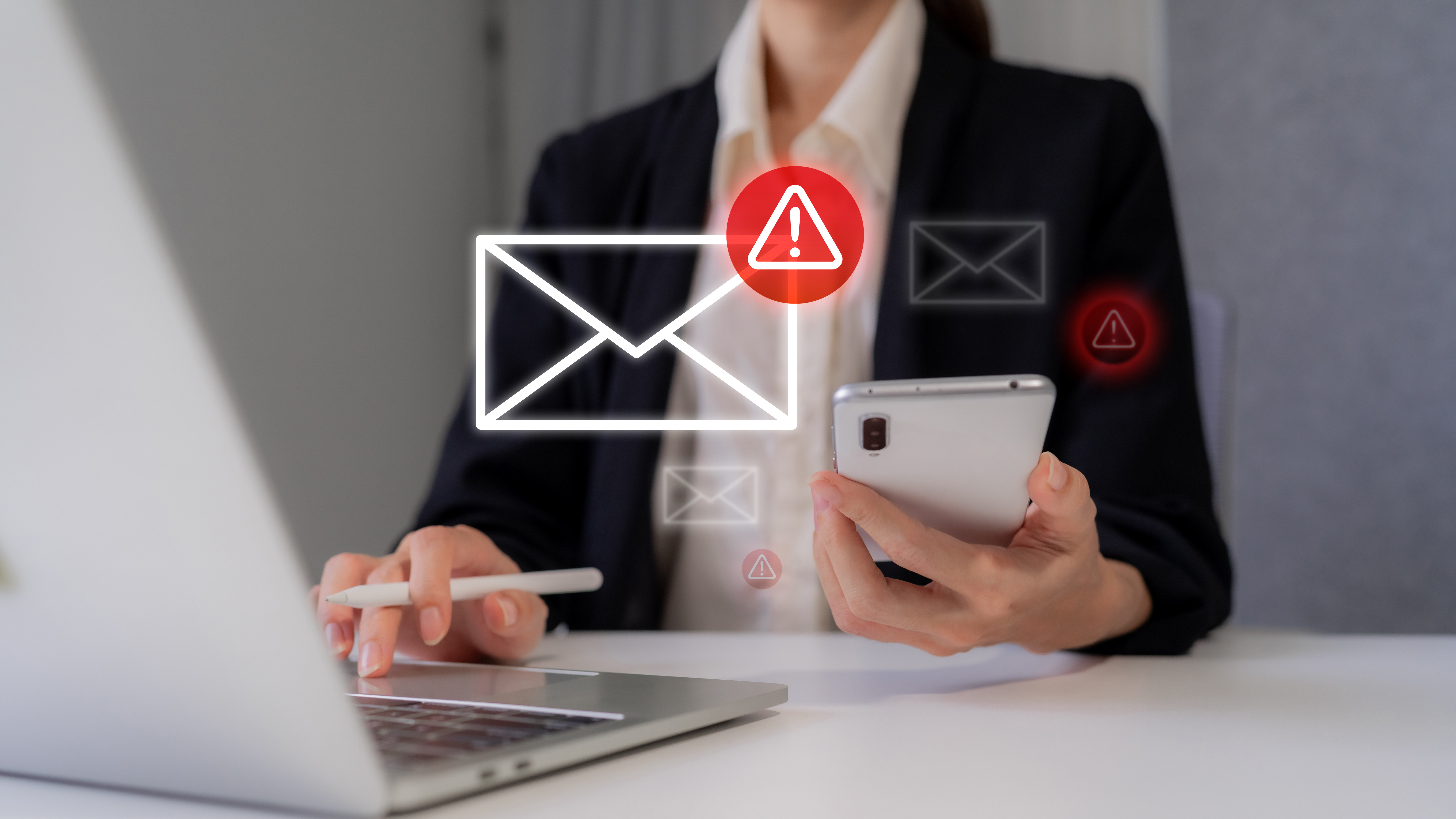 Business professional receives email warning alert notification dealing with digital security threats online at work using computer mobile phone