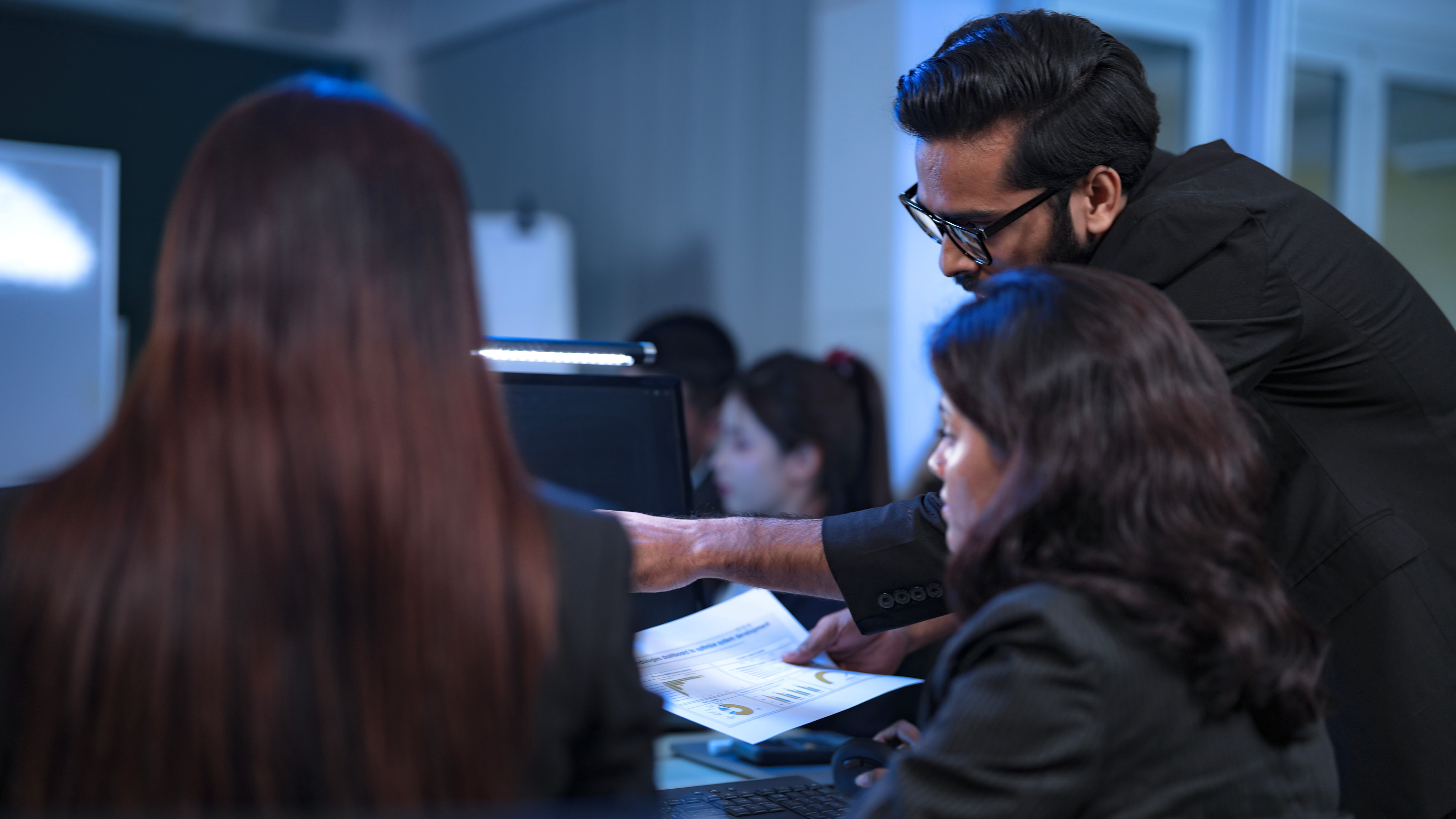 In a 24 7 Security Operations Center, a diverse incident response team works together under pressure, analyzing real-time threat intelligence data to defend against a live cyberattack.