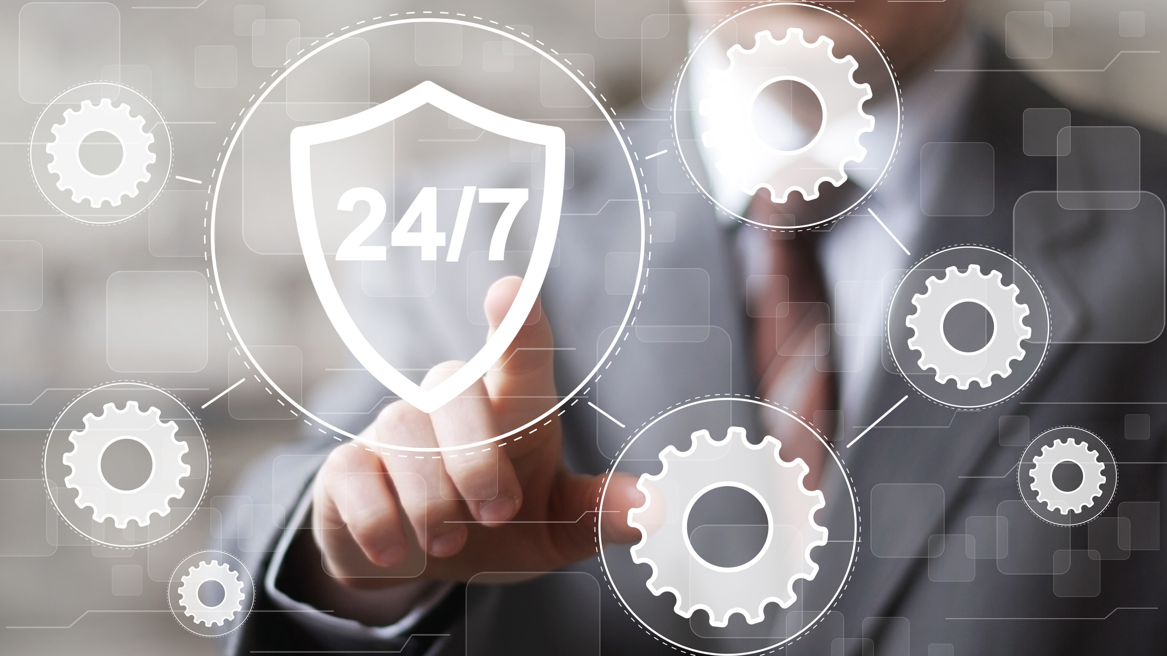 Businessman presses button 24 hours service shield security virus gear engineering network