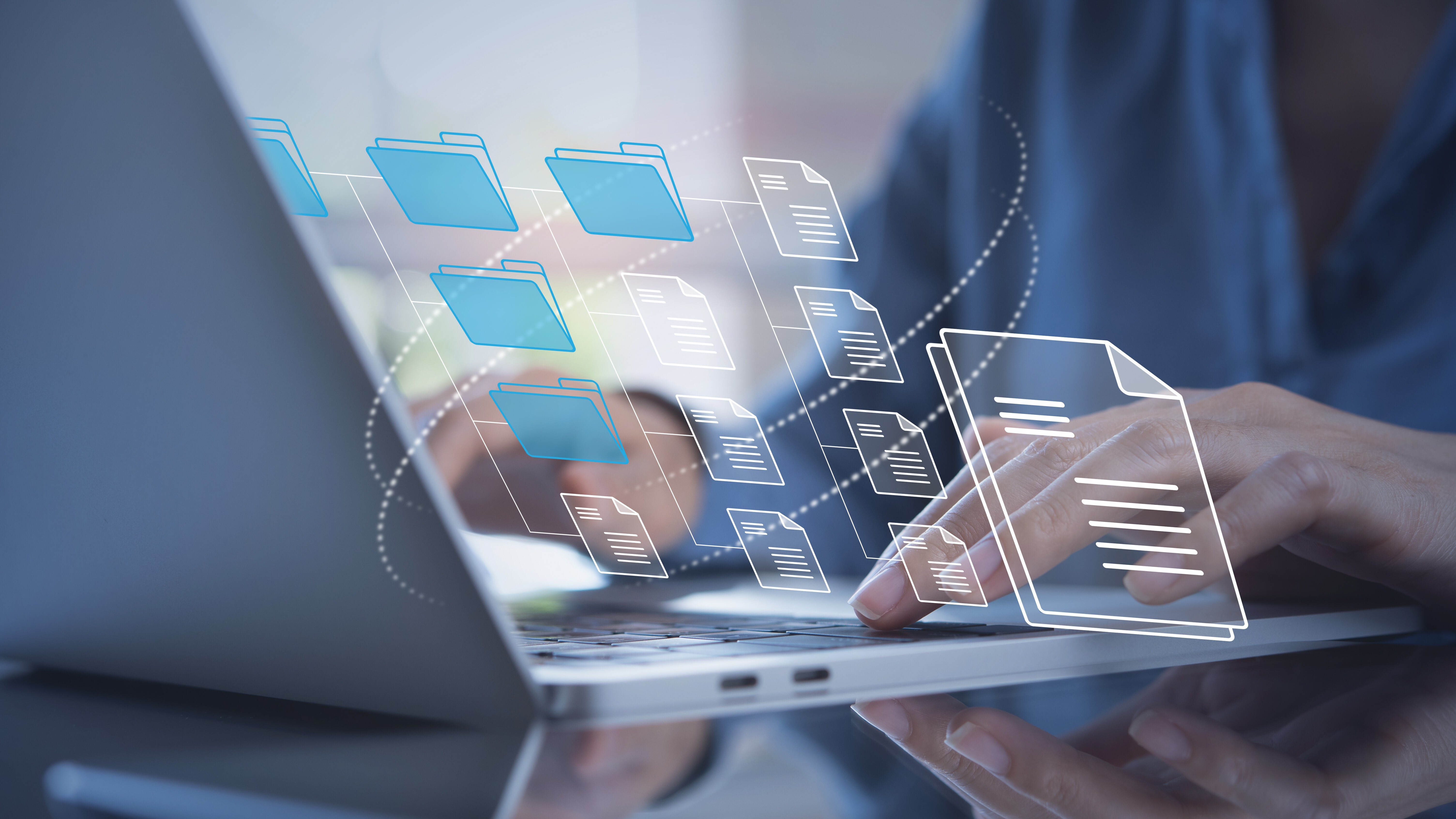 Document Management System (DMS) being setup by IT consultant working on laptop computer in office. Software for archiving corporate files