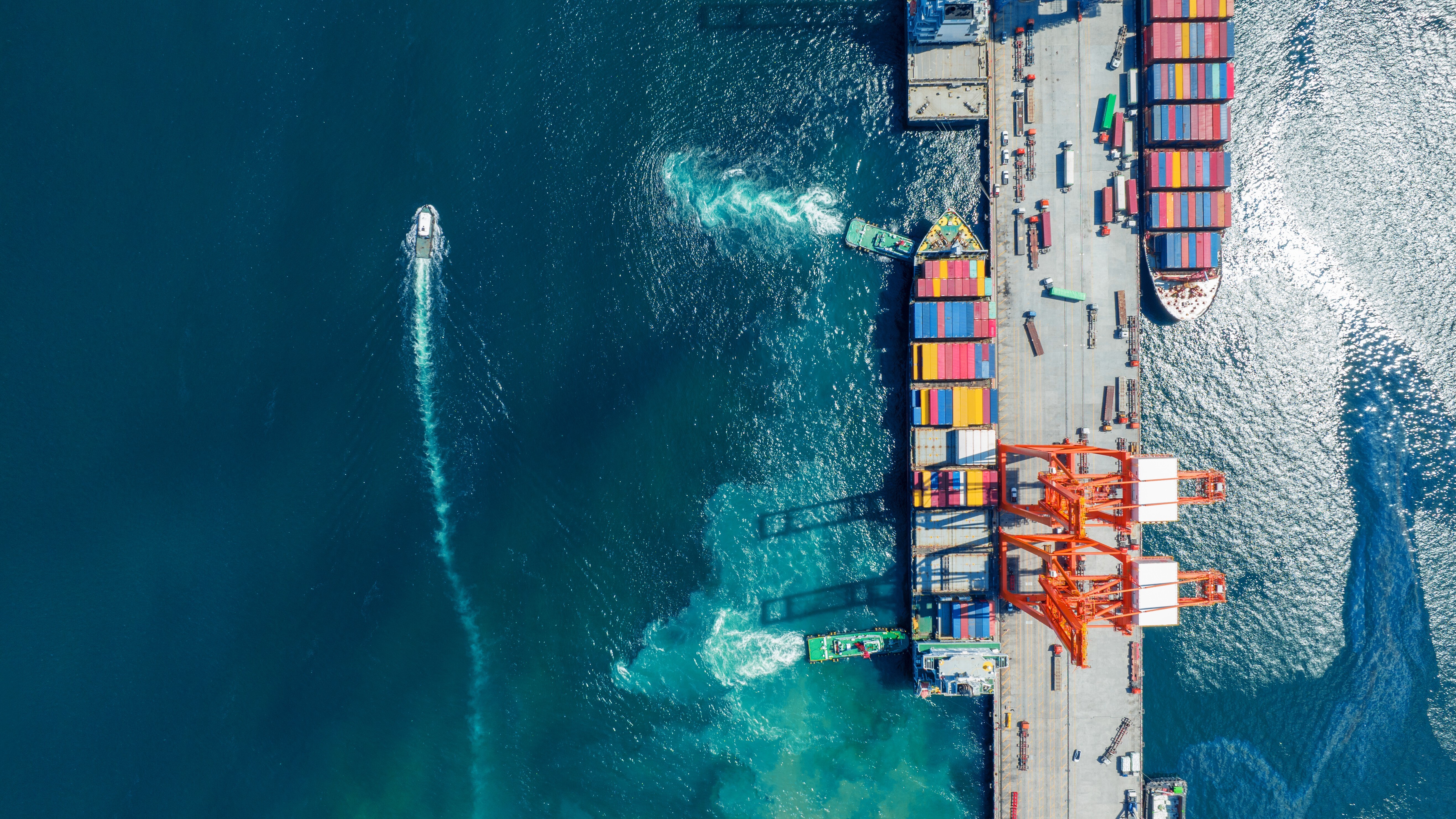 Cargo container Ship running to Bridge Cargo Shipyard Container ship under the crane Sea Port service logistics and transportation. 
