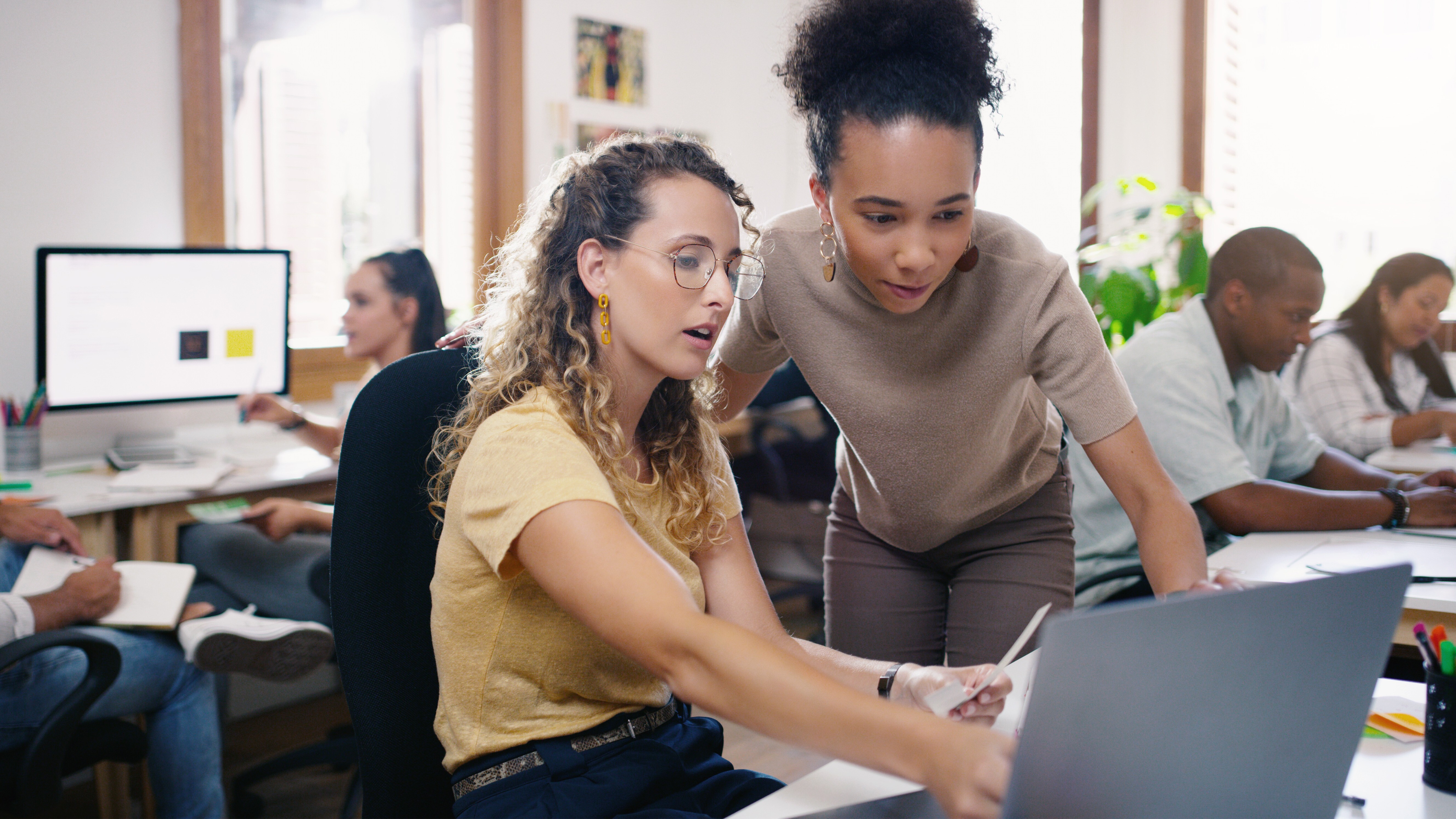 Talking, planning and business people in training with a laptop for leadership and mentoring. Meeting, project management and women speaking about online strategy, ideas or inspiration at work