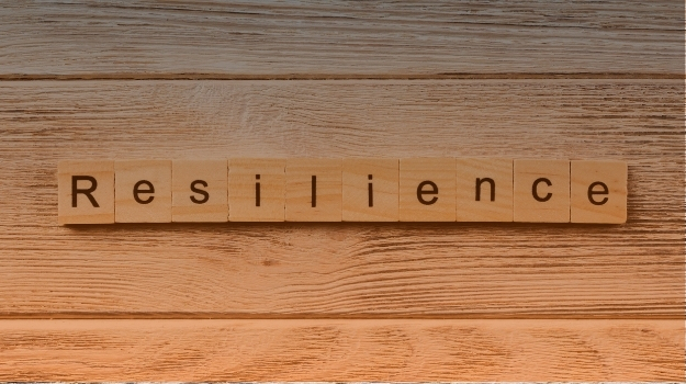 Resilience word written on wood block. resilience text on table, concept
